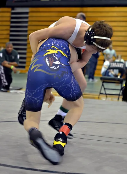 2 teen boys wrestling.